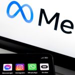 Meta logo on screen with a smartphone displaying social apps (Facebook, Messenger, Instagram, WhatsApp, Oculus)