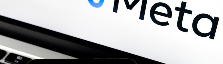 Meta logo on screen with a smartphone displaying social apps (Facebook, Messenger, Instagram, WhatsApp, Oculus)