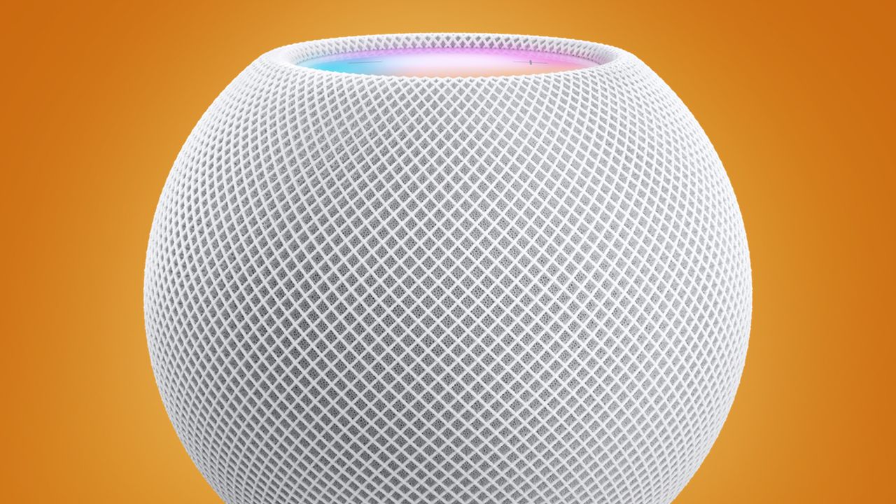 Close-up of a white spherical mesh smart speaker on an orange background with a subtle blue ring at the top edge.